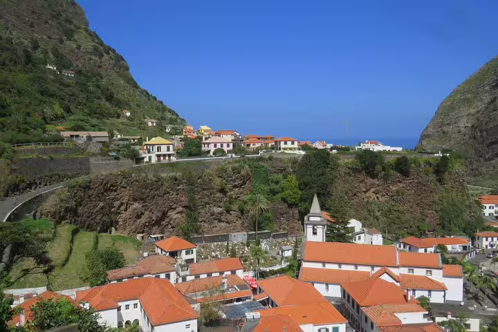 Scenic view of Madeira's lush mountains and charming hillside village, perfect for a full-day 4x4 adventure tour.