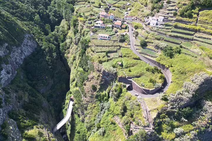 Aerial view of Madeira's lush terraced landscapes and winding roads, perfect for a full day private 4x4 adventure tour.