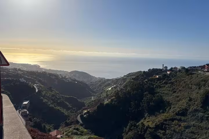 Panoramic coastal valley view in rural Madeira on a 4x4 tour, with winding roads and Atlantic horizon