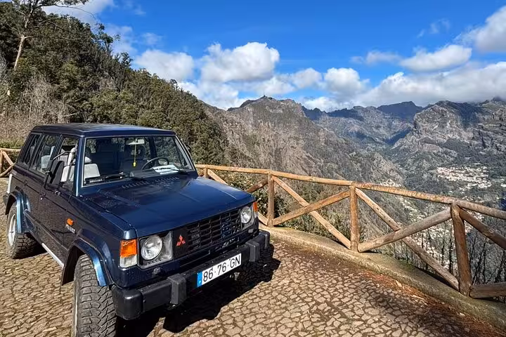 4x4 jeep at Madeira mountain viewpoint on Cultural Rural Madeira 4x4 Experience with rugged peaks and sky