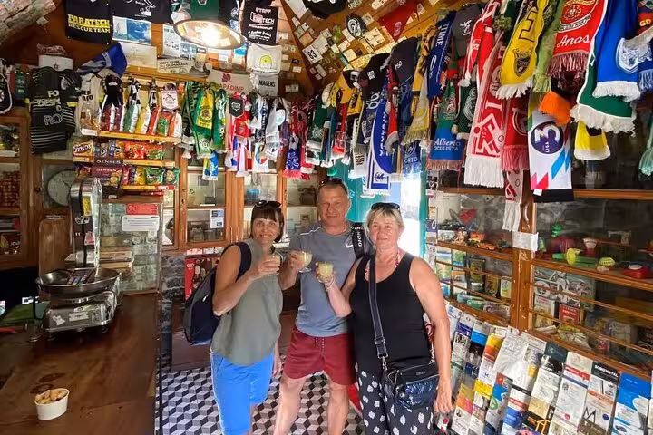 Guests tasting poncha in a traditional Madeira bar, colorful decor on Cultural Rural Madeira 4x4 tour