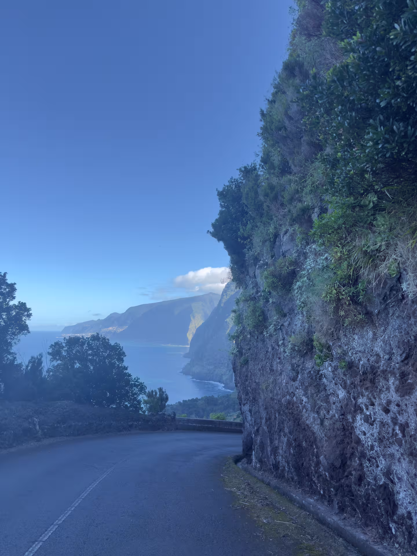 Cliffside coastal road with Atlantic views and dramatic mountains, highlight of North Wonders 4x4 adventure tour