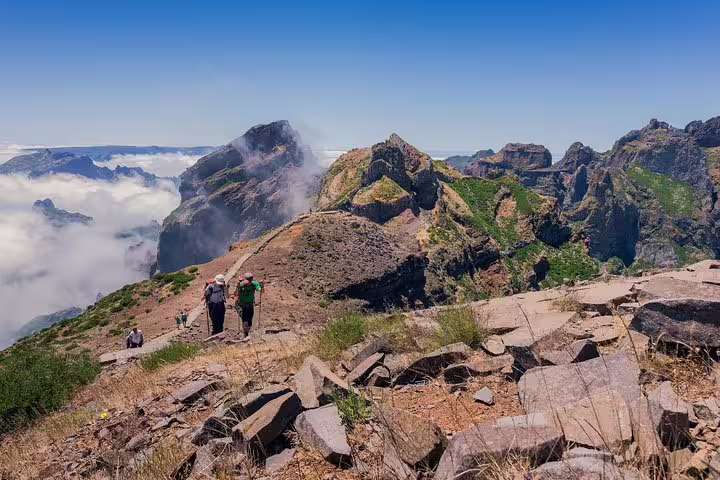 Hikers explore the rugged peaks of Madeira with panoramic views and lush greenery on the Full Day East Madeira Tour.