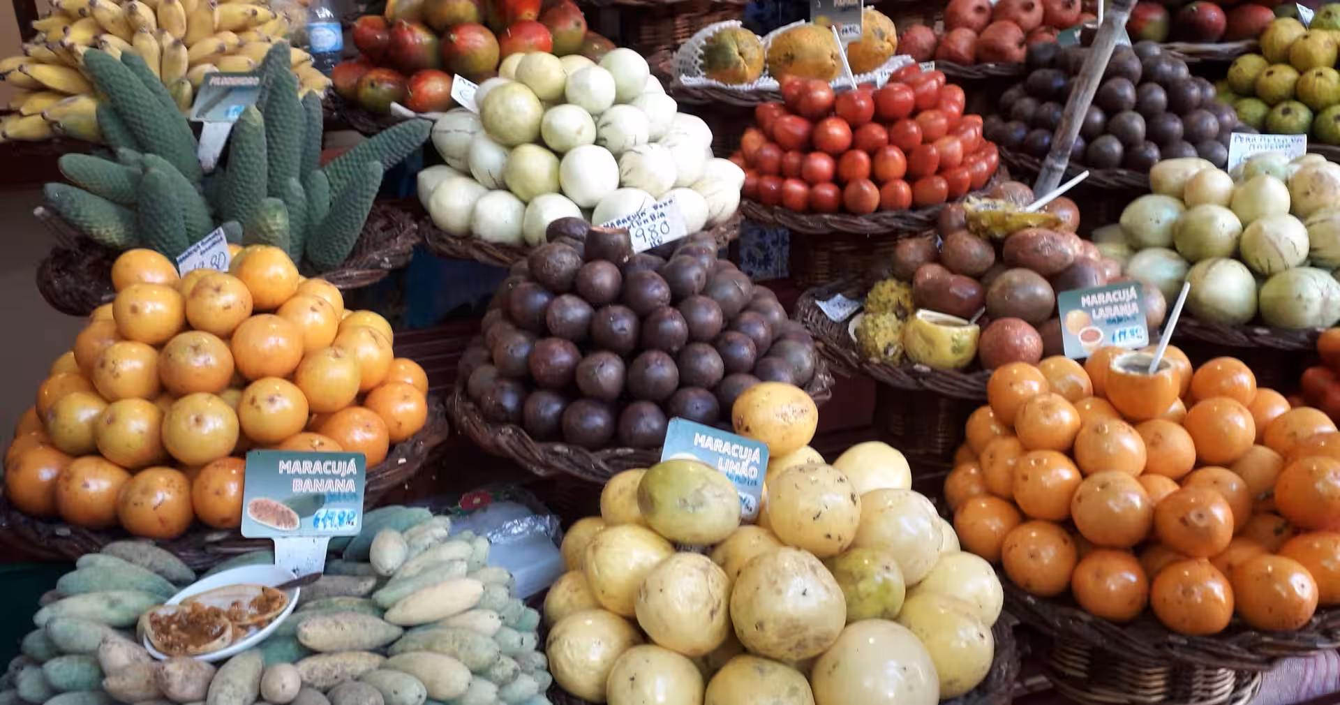 Colorful Madeira farmers market fruit stalls in Funchal, a tasty stop on the 4-day cultural highlights tour