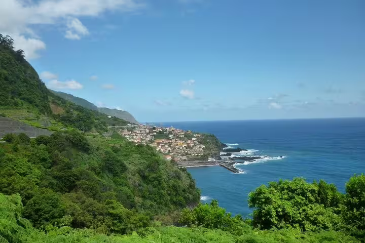 Stunning coastal view of Madeira Island with a charming village overlooking the deep blue Atlantic Ocean, ideal for exploration.