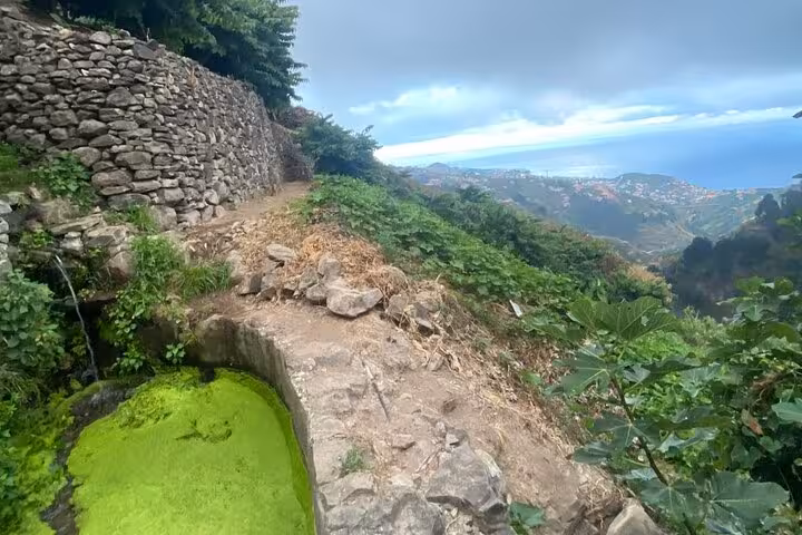 Stone levada path and hillside viewpoint over Madeira coast, seen on Cultural Rural Madeira 4x4