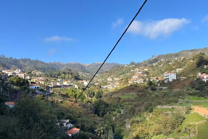 Wide view of Madeira mountain villages and green valleys under blue sky on a Cultural Rural Madeira 4x4