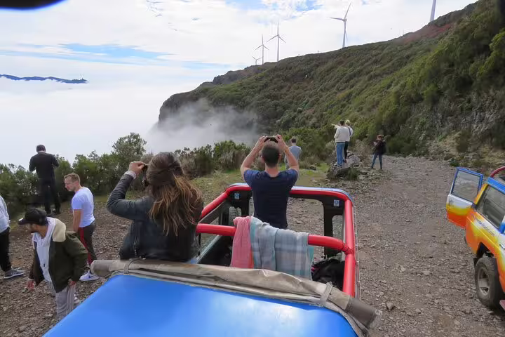 Adventurers capture stunning mountain views and wind turbines during a thrilling 4x4 tour in Madeira's northwest frontier.