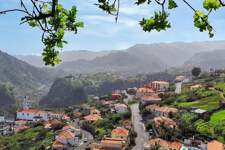 Scenic view of Madeira village nestled in lush green valleys and mountains, perfect for exploring on a full-day 4x4 tour.