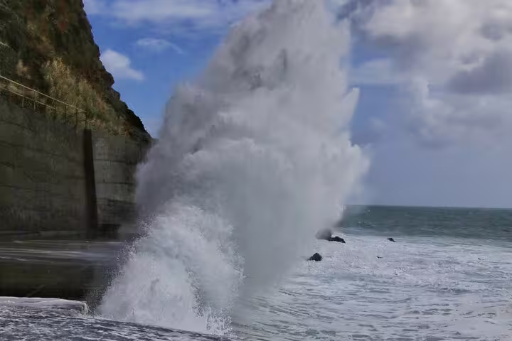 Crashing waves against Madeira's cliffs under a vibrant sky, perfect for scenic Enchanted Terraces & Fanal UNESCO jeep tours.