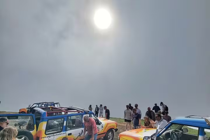 Tourists enjoy an open-top jeep adventure under a bright sky at Madeira's Enchanted Terraces & Fanal UNESCO site.