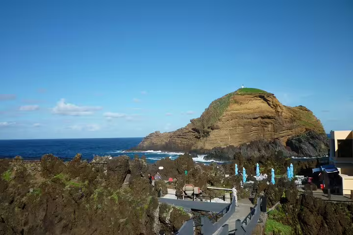 Explore the stunning volcanic rock formations and coastal views at Madeira's Porto Moniz natural swimming pools.