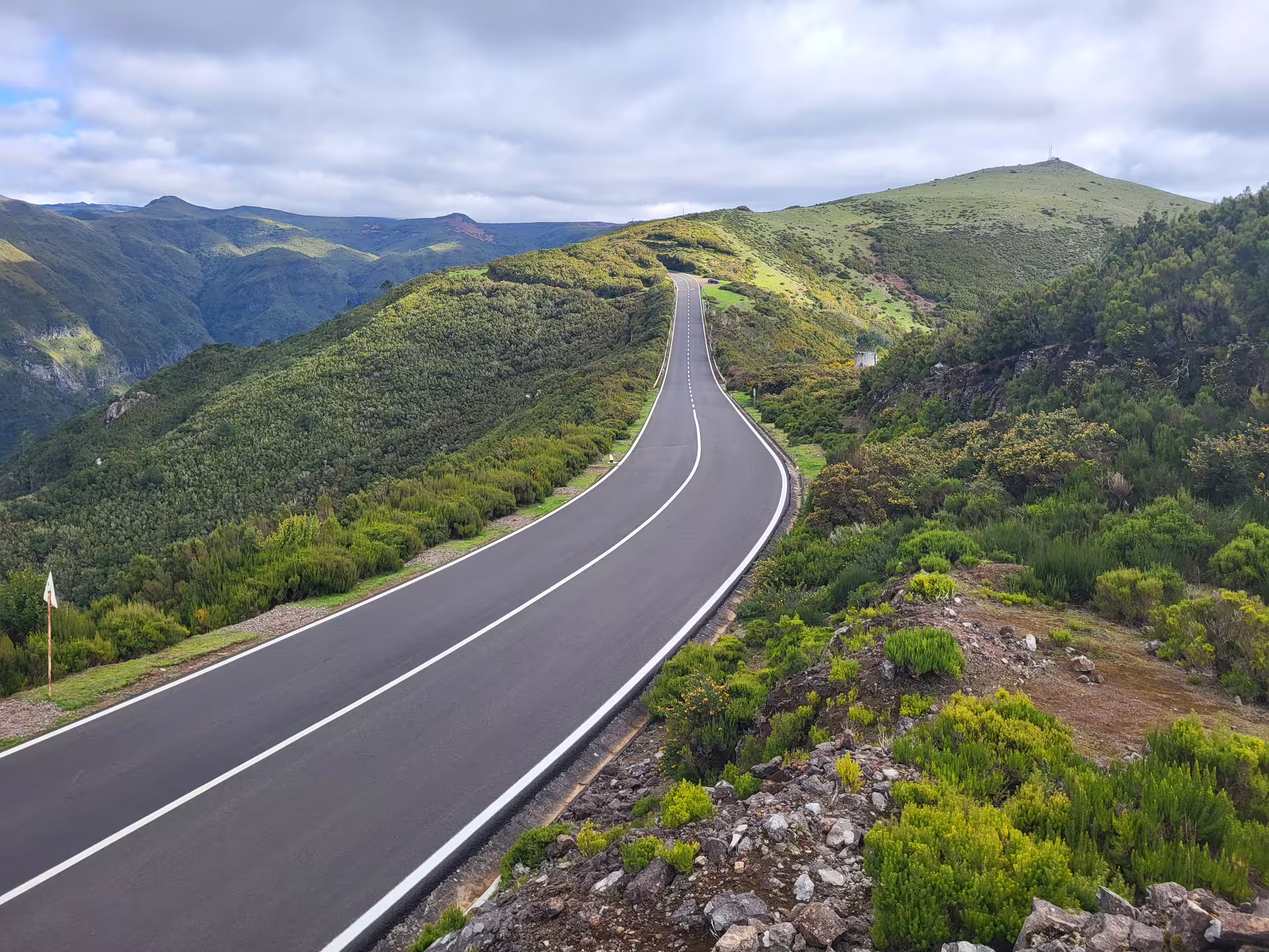 Scenic road through lush green hills in Madeira, perfect for a private tour exploring stunning landscapes in total comfort.
