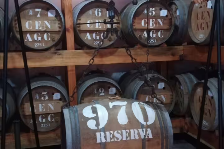Close-up of rum barrels labeled '970 Reserva' at a Madeira distillery, key attraction on the east island safari tour.