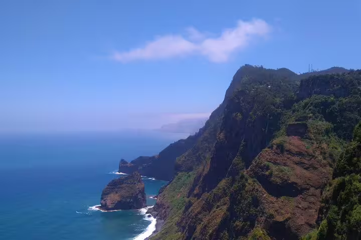 Stunning coastal cliffs of eastern Madeira with rugged rock formations and turquoise Atlantic waves, perfect for adventure seekers.