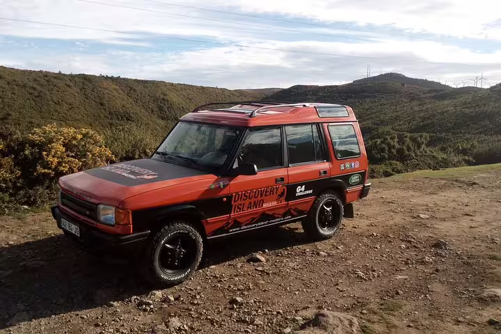 Off-road safari jeep parked amidst Madeira's lush western landscapes, ready for an adventurous island exploration.