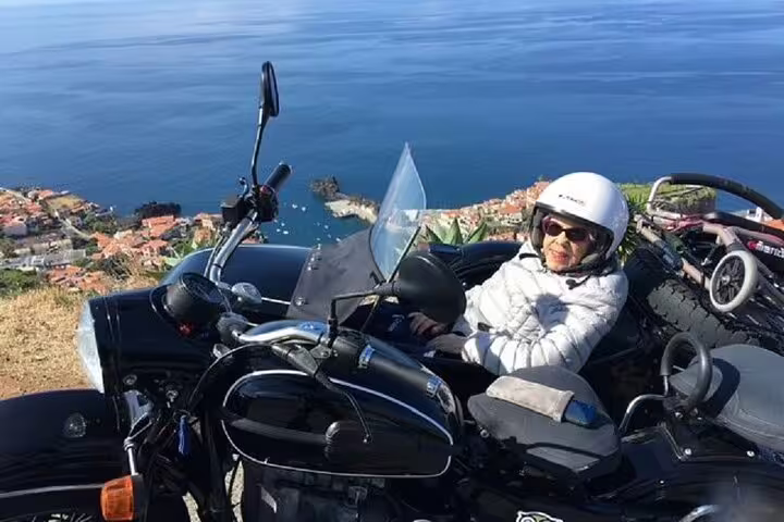 Sidecar tour on Madeira Old Road West with stunning ocean views, ideal for adventurous travelers exploring scenic coastal routes.