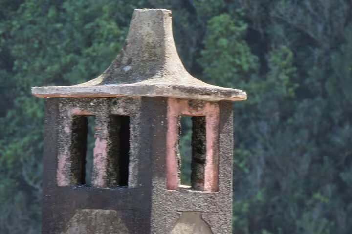 Close-up of a rustic stone chimney in Madeira's lush landscape, perfect for a scenic 4x4 adventure tour.