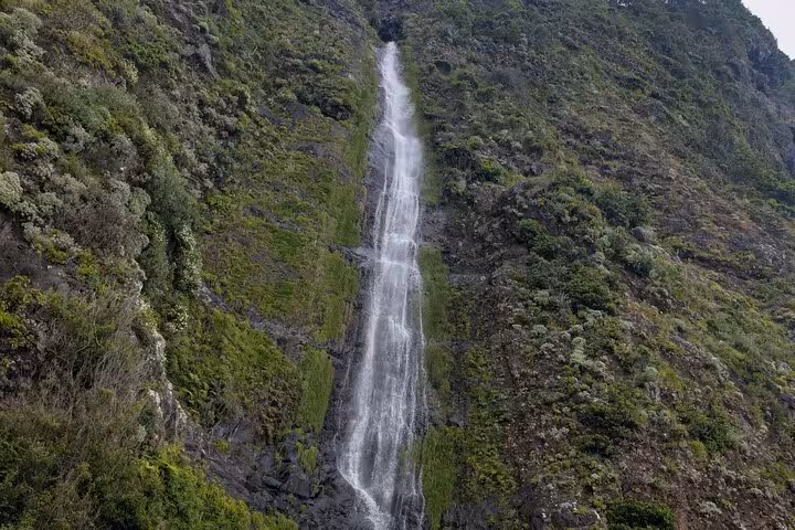 Tall waterfall cascading down lush cliffs in Madeira, a scenic stop on the West Madeira 4x4 expedition
