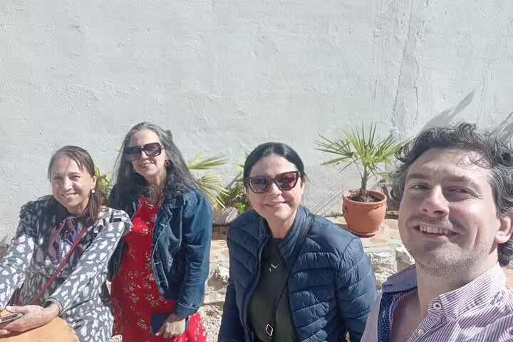Group enjoying a sunny day at a Chinchón winery, capturing the essence of social experiences on a Madrid wine tour.