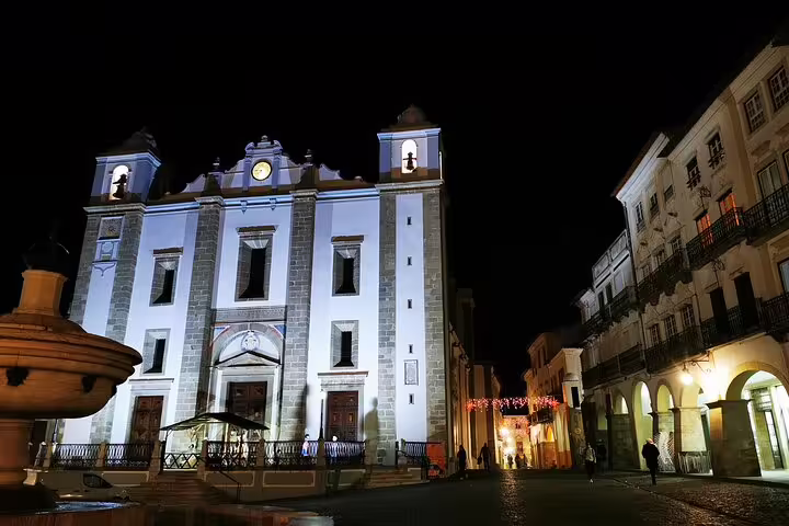 Night view of an illuminated historic church in Évora, Portugal, a scenic stop on the Madrid to Lisbon private transfer tour.