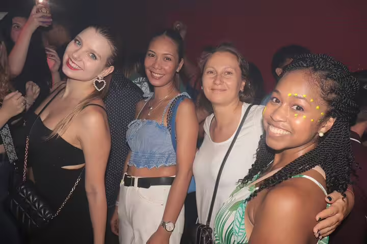 Group of friends enjoying nightlife on a lively Madrid pub crawl tour, showcasing vibrant party atmosphere.