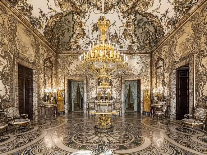 Ornate chandelier hall inside Madrid Royal Palace, a highlight of the Historias Locales guided tour