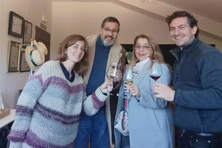 Group enjoying wine tasting at Madrid winery with expert sommelier guidance and cozy atmosphere.