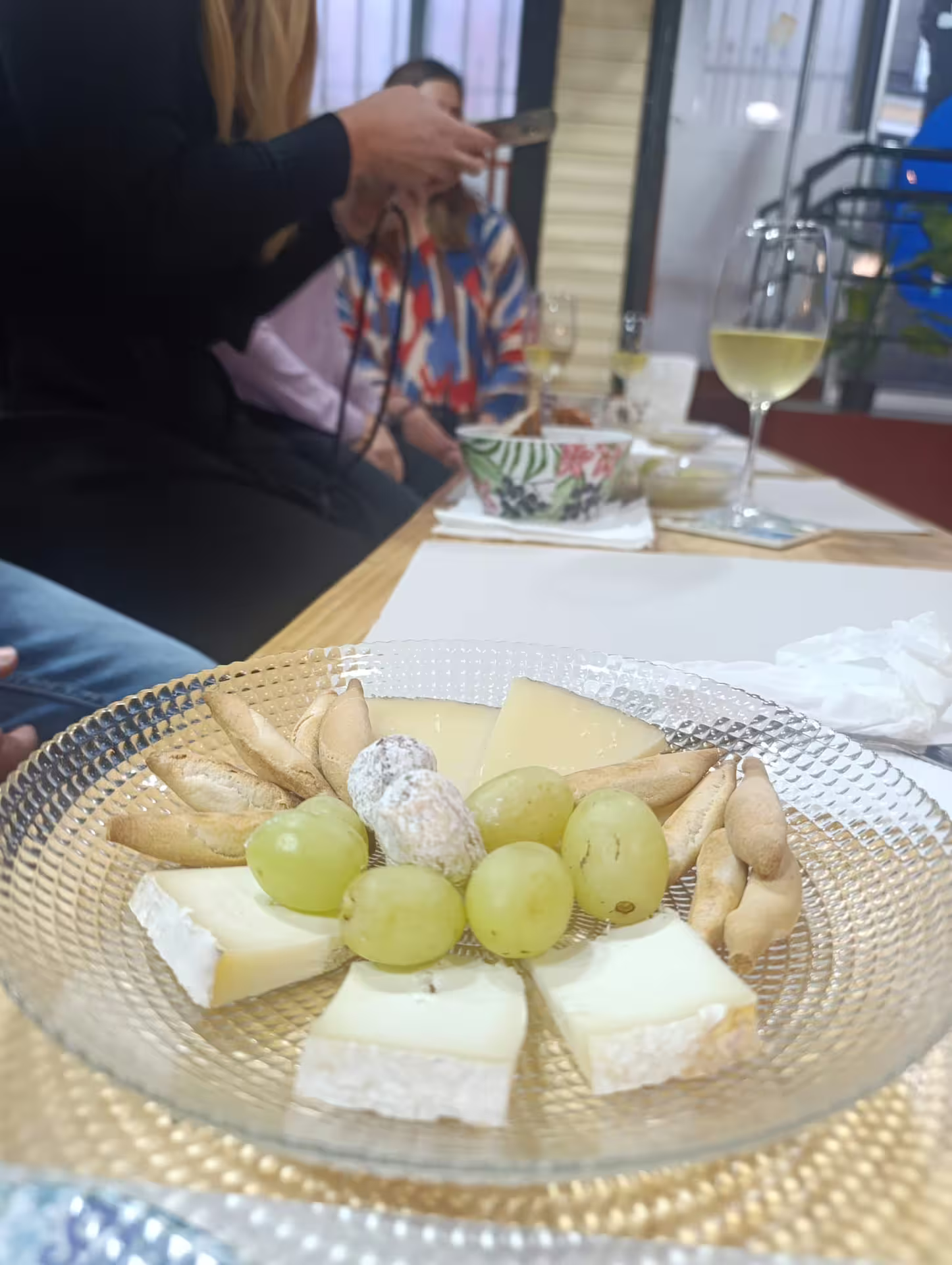 Cheese and grape platter with wine glass at Madrid City Wine Tour tasting session.