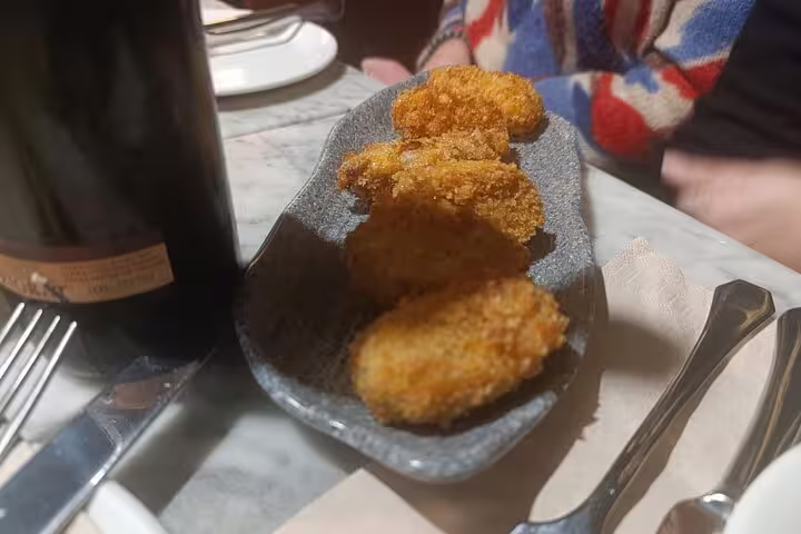 Crispy golden croquettes served with wine on Madrid City Wine Tour pairing experience.