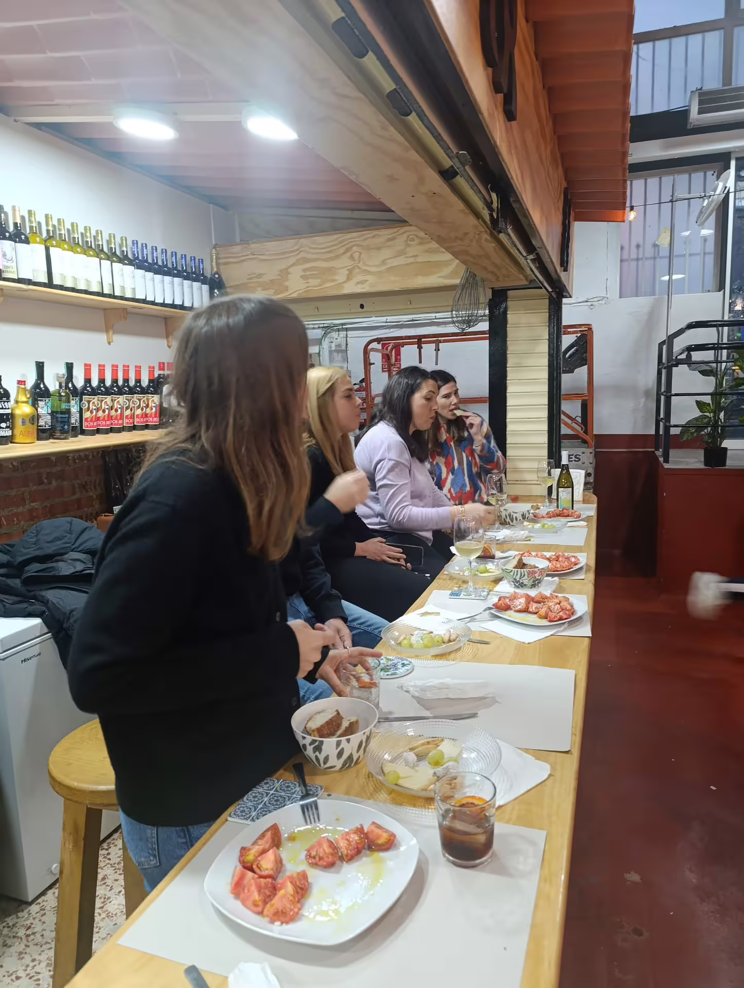 Group enjoying wine pairing with Spanish tapas during Madrid City Wine Tour.