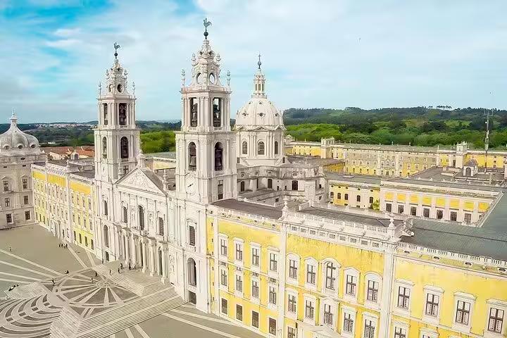 Aerial view of the grand Mafra Palace with its baroque architecture, a highlight of the Mafra, Ericeira, and Queluz tour from Lisbon.