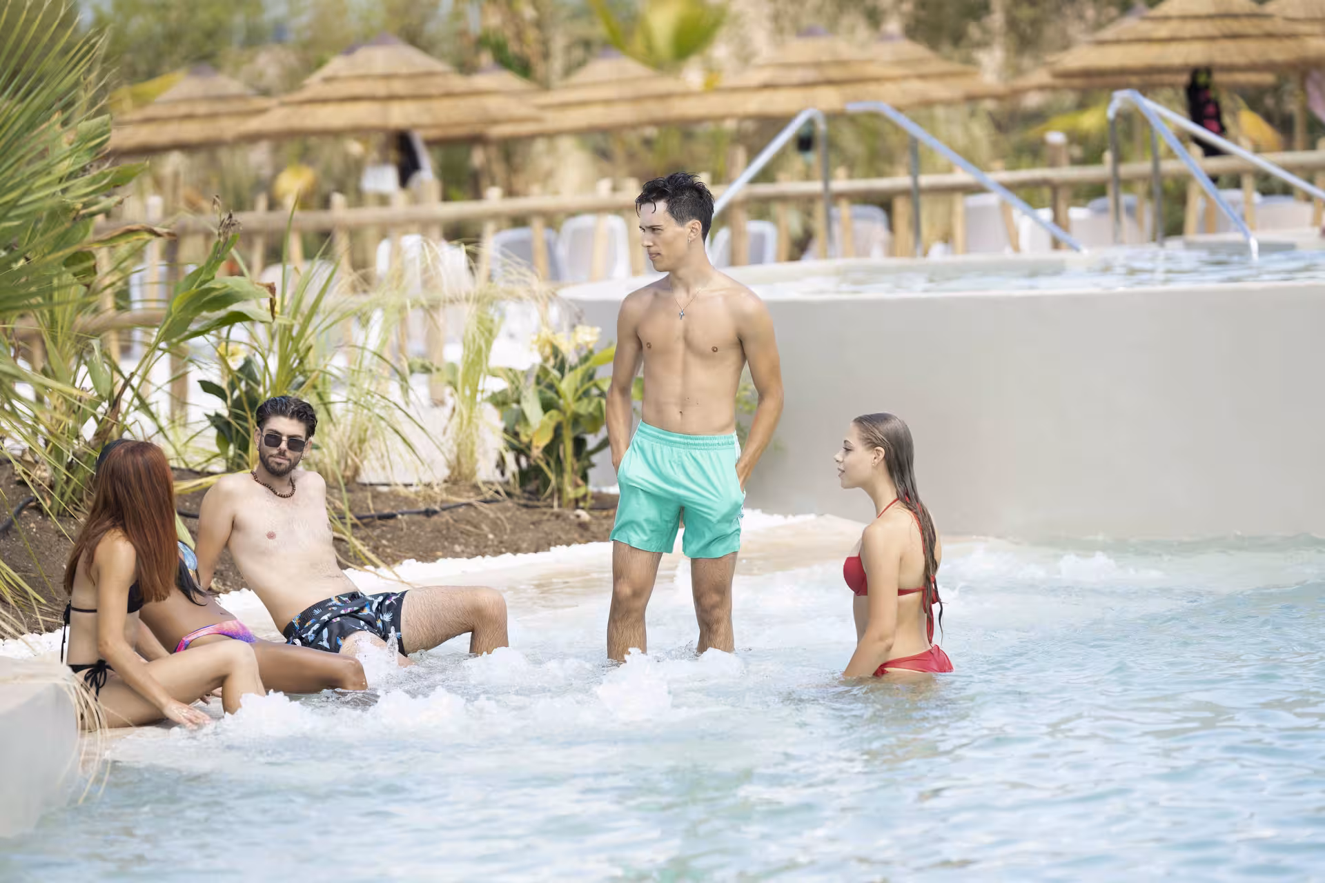 Friends relaxing in a bubbling lagoon pool at MagicSplash, Rome day trip to MagicLand water park fun
