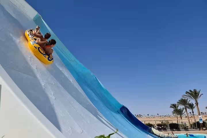 Thrilling tube ride down Makadi Water World Aqua Park slide on a day trip from Hurghada with lunch included