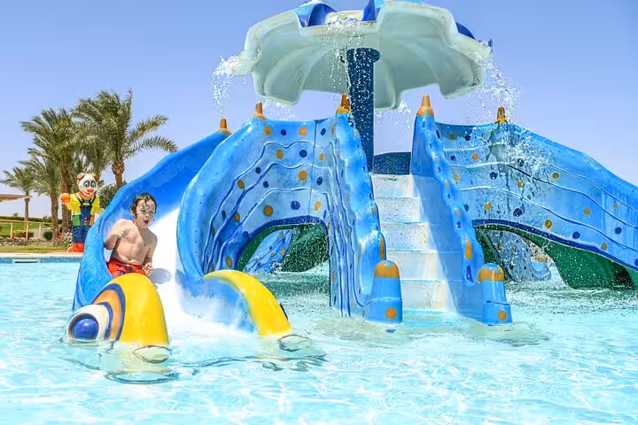 Kids splash zone at Makadi Water World Aqua Park with water play structure, day trip from Hurghada