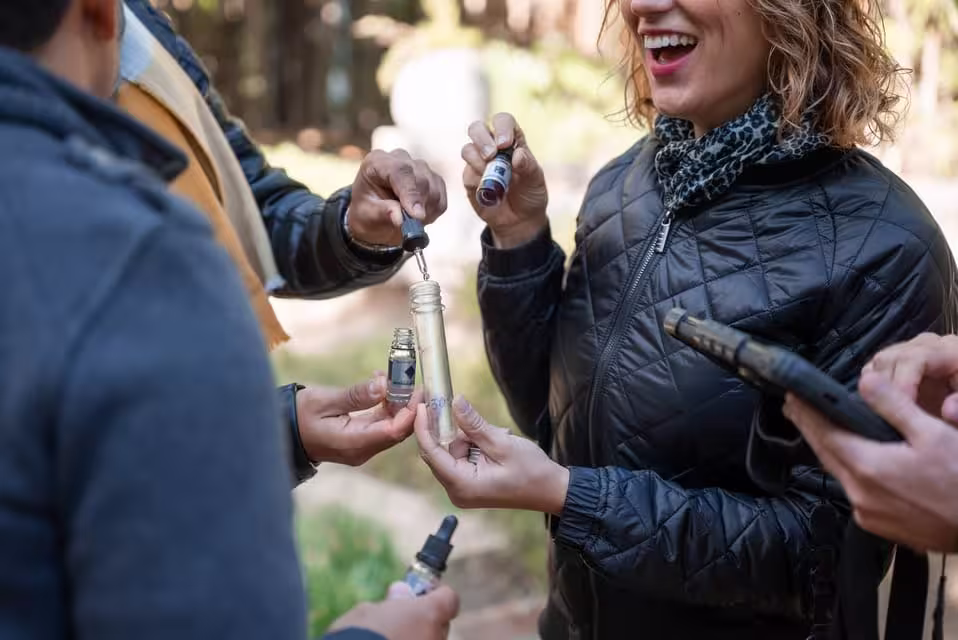 Participants collaborate using vials and tools in challenging Malaga BlackOut outdoor escape game.