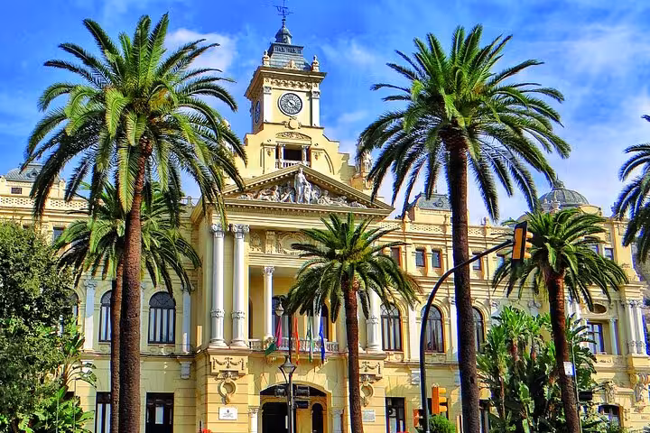 Elegant facade of Malaga City Hall surrounded by palm trees, a charming stop on the Galicia Portugal Andalucia tour.