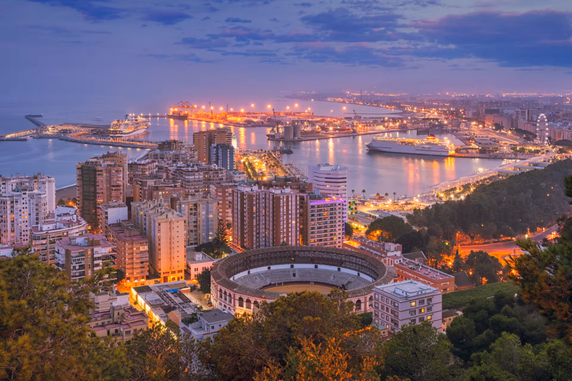 Málaga harbor and city lights at dusk, panoramic viewpoint on a free night walking tour of Málaga