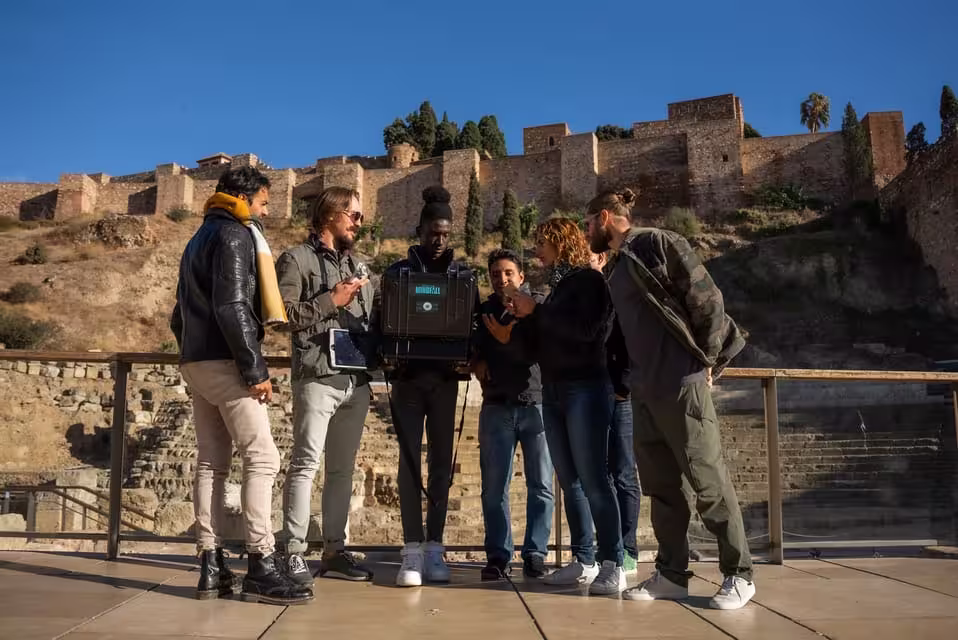 Team solving clues during the Malaga Outdoor Escape Game Operation Mindfall with a historic backdrop.