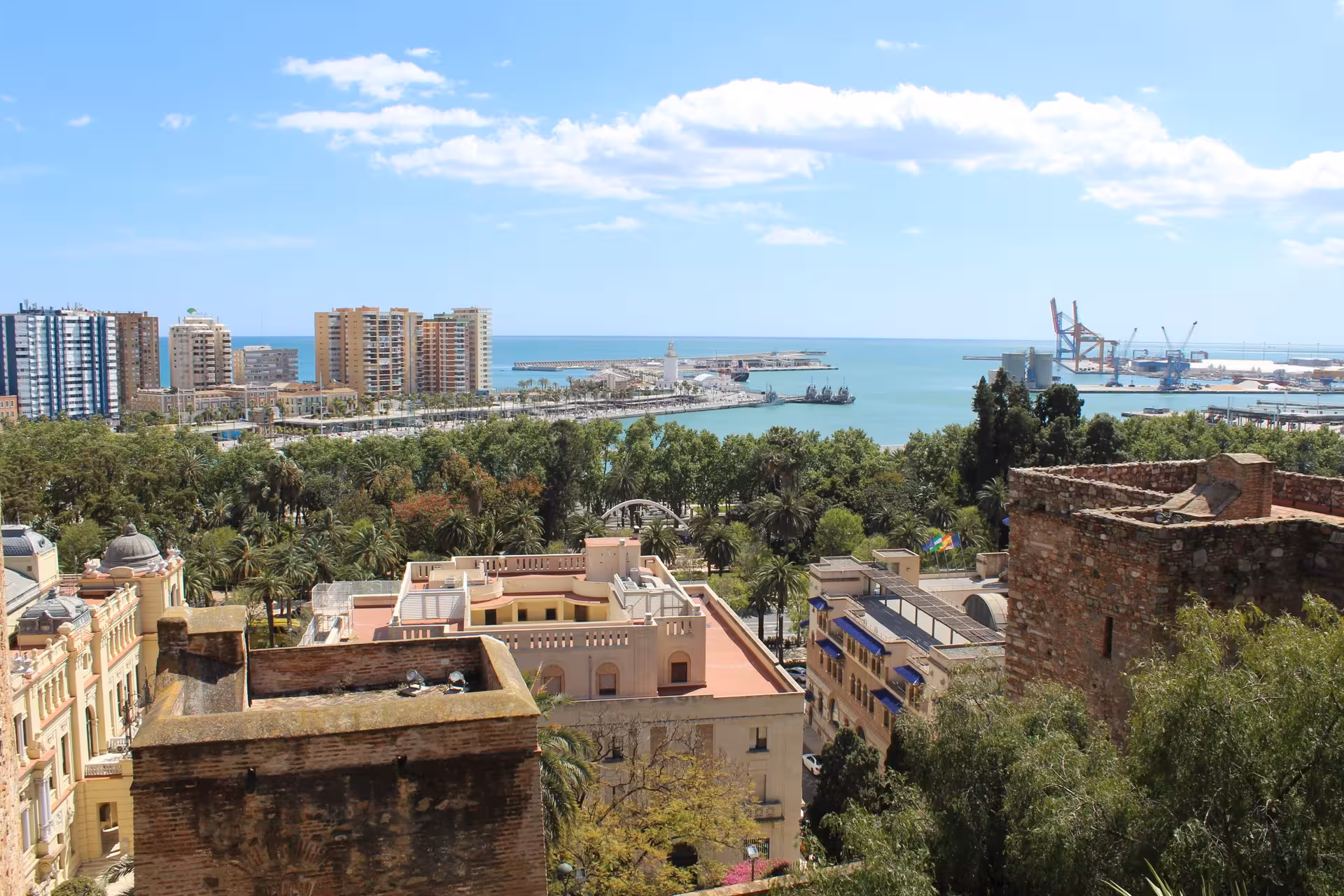 Panoramic view of Malaga port and coastline from Gibralfaro viewpoint, a highlight on the Free Tour in Malaga