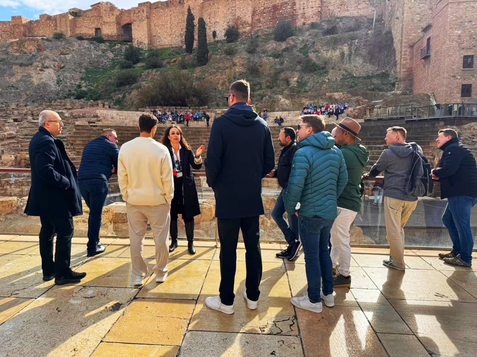 Private Malaga tour group at Roman Theatre with Alcazaba fortress walls, day trip from Marbella