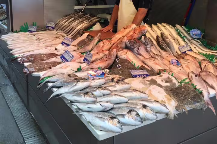 Fresh seafood display at a Malaga market, highlighting local fish varieties for an authentic city tour experience.