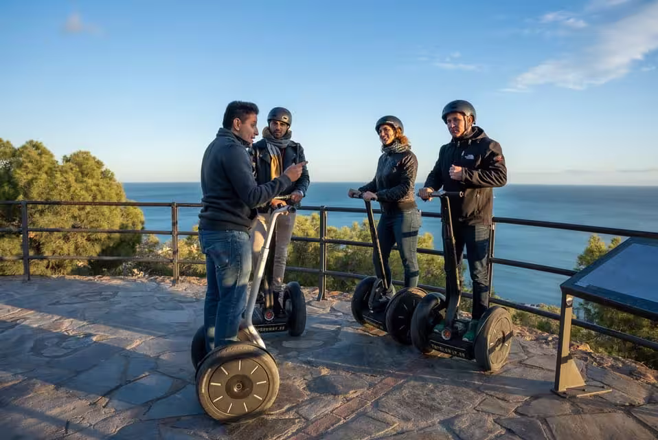 Group on Segways enjoying scenic views of Malaga's coastline during a 2-hour monumental city tour.