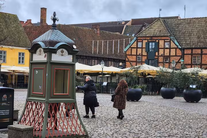Cobbled square with vibrant buildings and visitors in Malmo's cultural center.