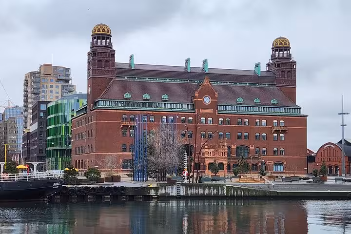 Historic building view in Malmö with waterfront reflection, showcasing iconic architecture for a 4-hour city highlights tour.
