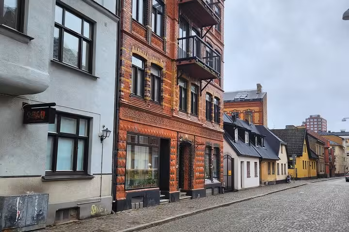 Colorful mix of historic and modern architecture on a serene street in Malmo, showcasing the city's urban charm.