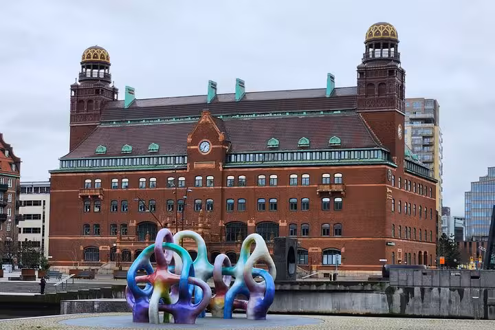 Vibrant sculpture in front of a historic Malmö building, capturing the city's artistic flair on a 4-hour highlights tour.