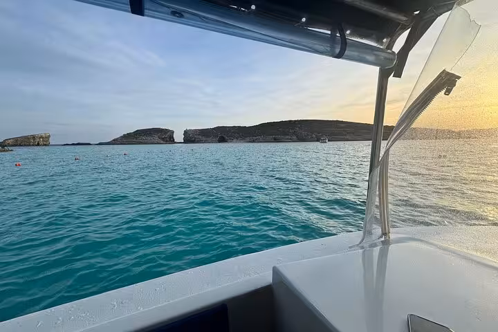 Boat deck overlooking Comino Blue Lagoon and sea caves on a half-day Malta to Gozo cruise