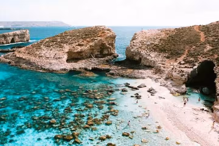 Crystal-clear lagoon and rocky coastline at Comino near Gozo, ideal swim stop on Malta half-day island tour