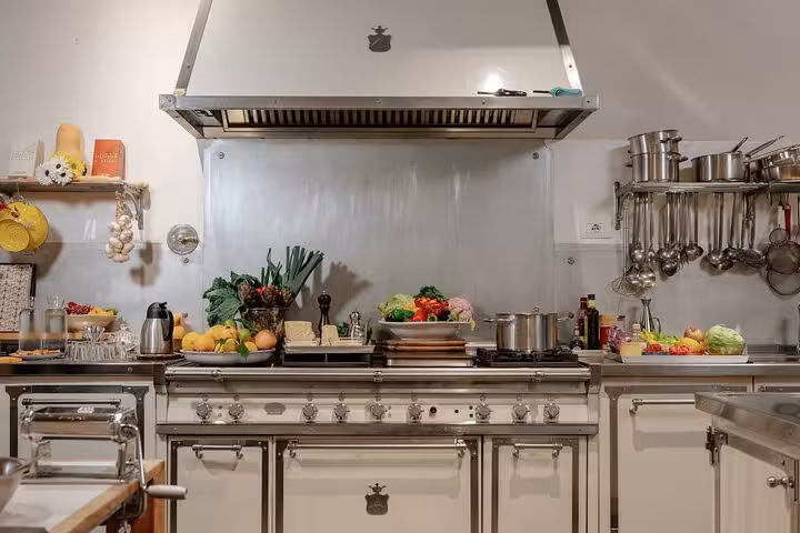 A professional kitchen setup with fresh ingredients and pasta-making tools for a hands-on class in Florence.